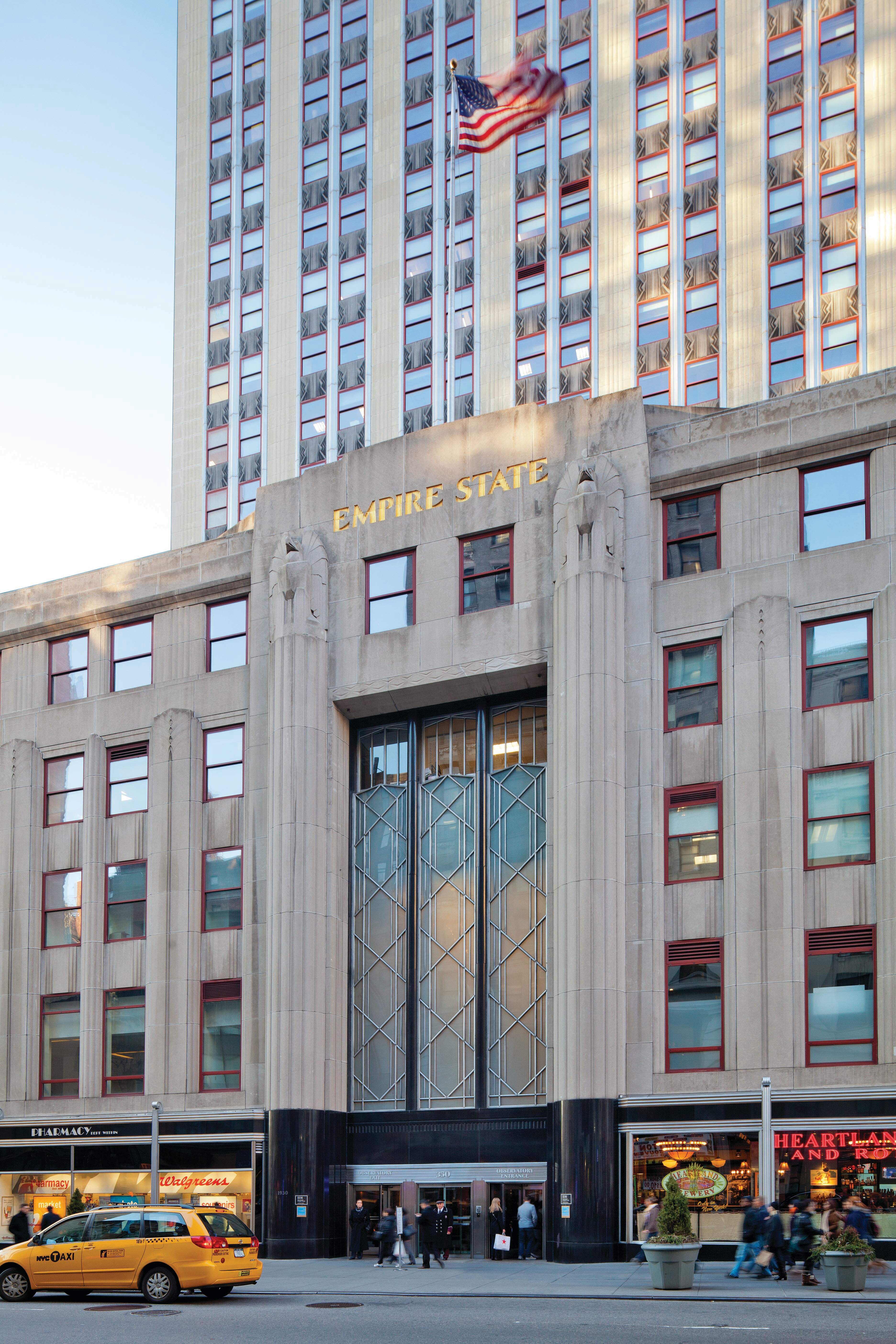 Empire State Building exterior building identification with gold lettering inlaid on stone facade, designed by Two Twelve
