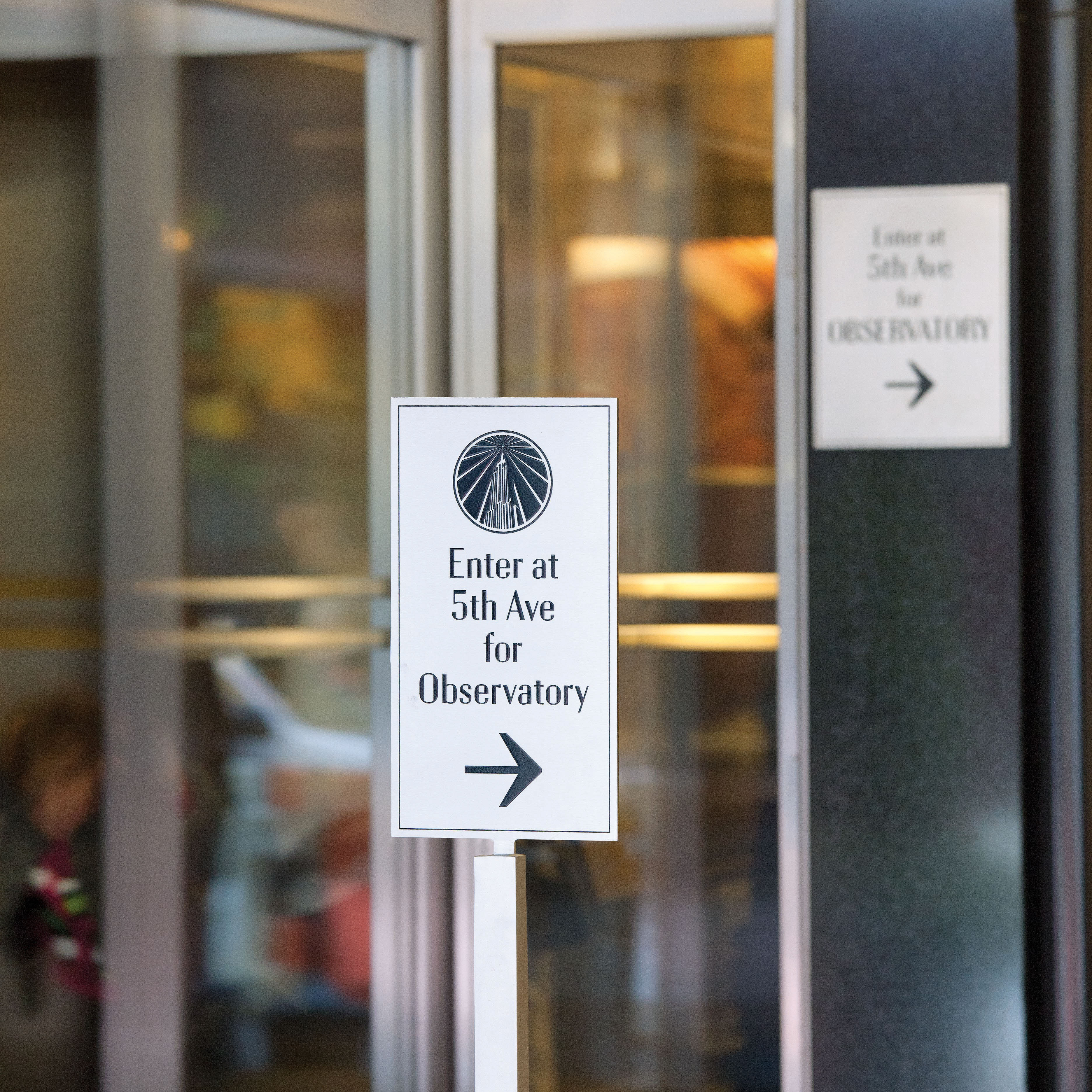 Empire State Building small exterior ground-standing directional sign for Observatory, designed by Two Twelve