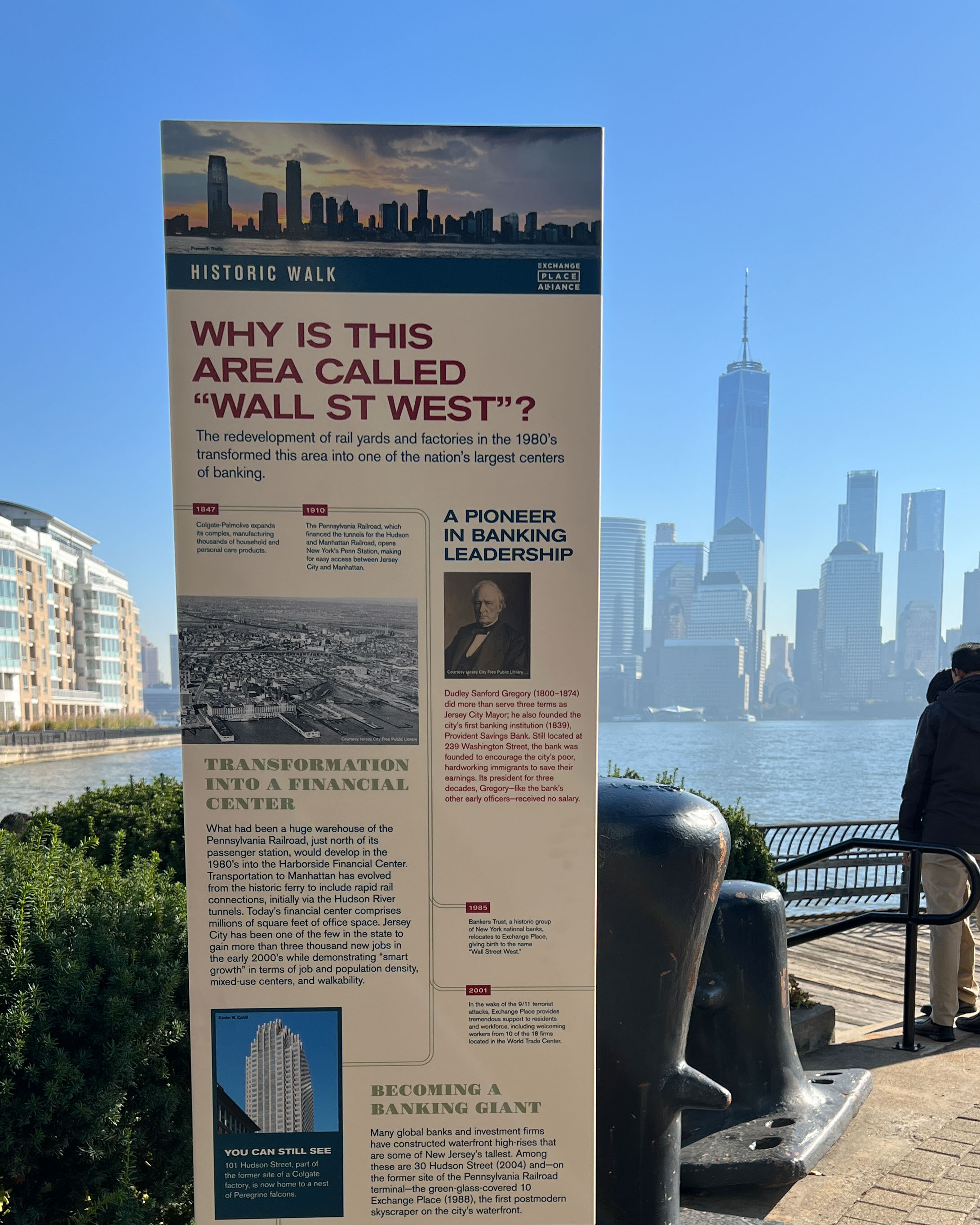 Exchange Place exterior ground-standing informational sign about Wall Street West with timeline, designed by Two Twelve