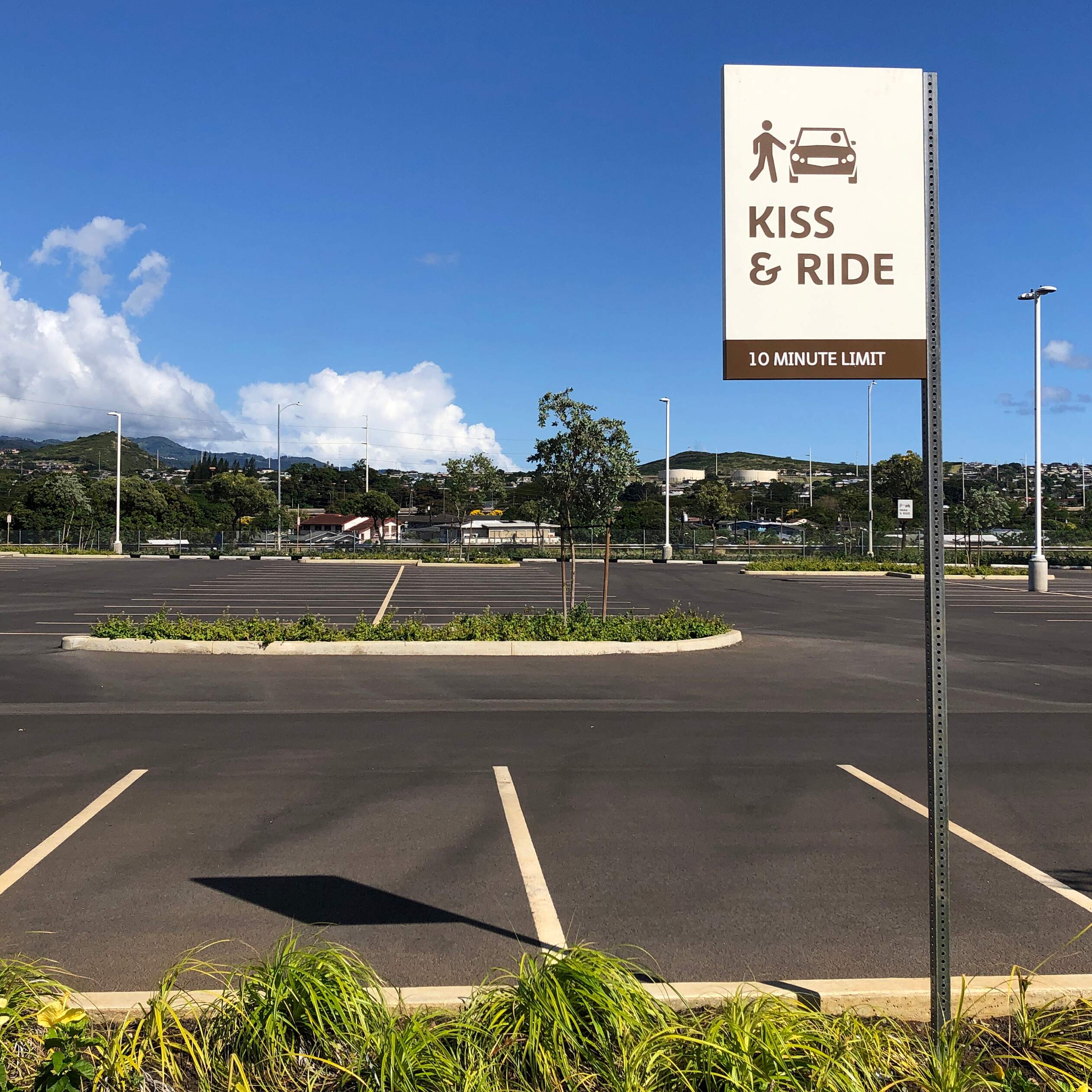 Honolulu TOD Transit Corridor kiss-and-ride post-mounted sign in parking lot, designed by Two Twelve