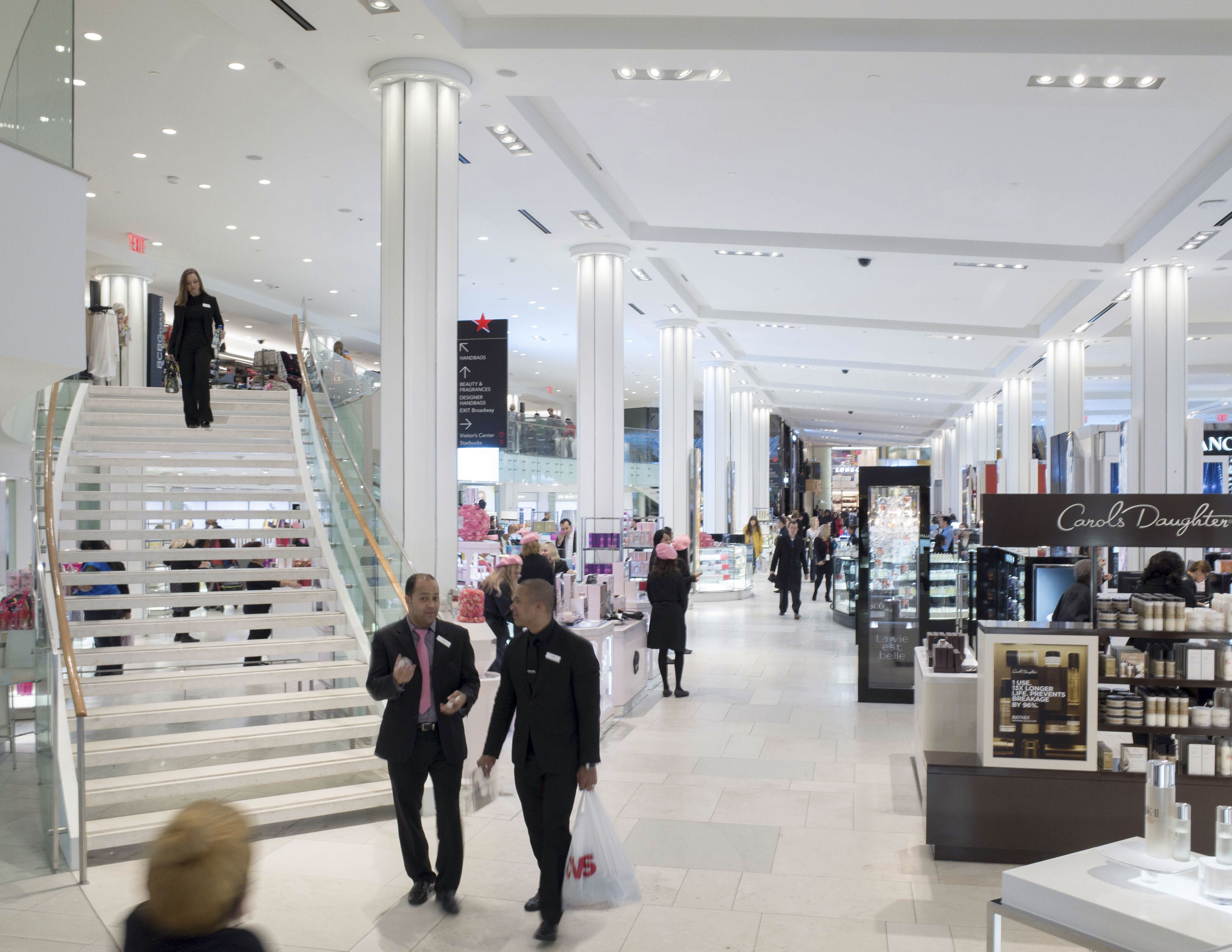Macy's Herald Square interior directional column-mounted sign with store branding, designed by Two Twelve