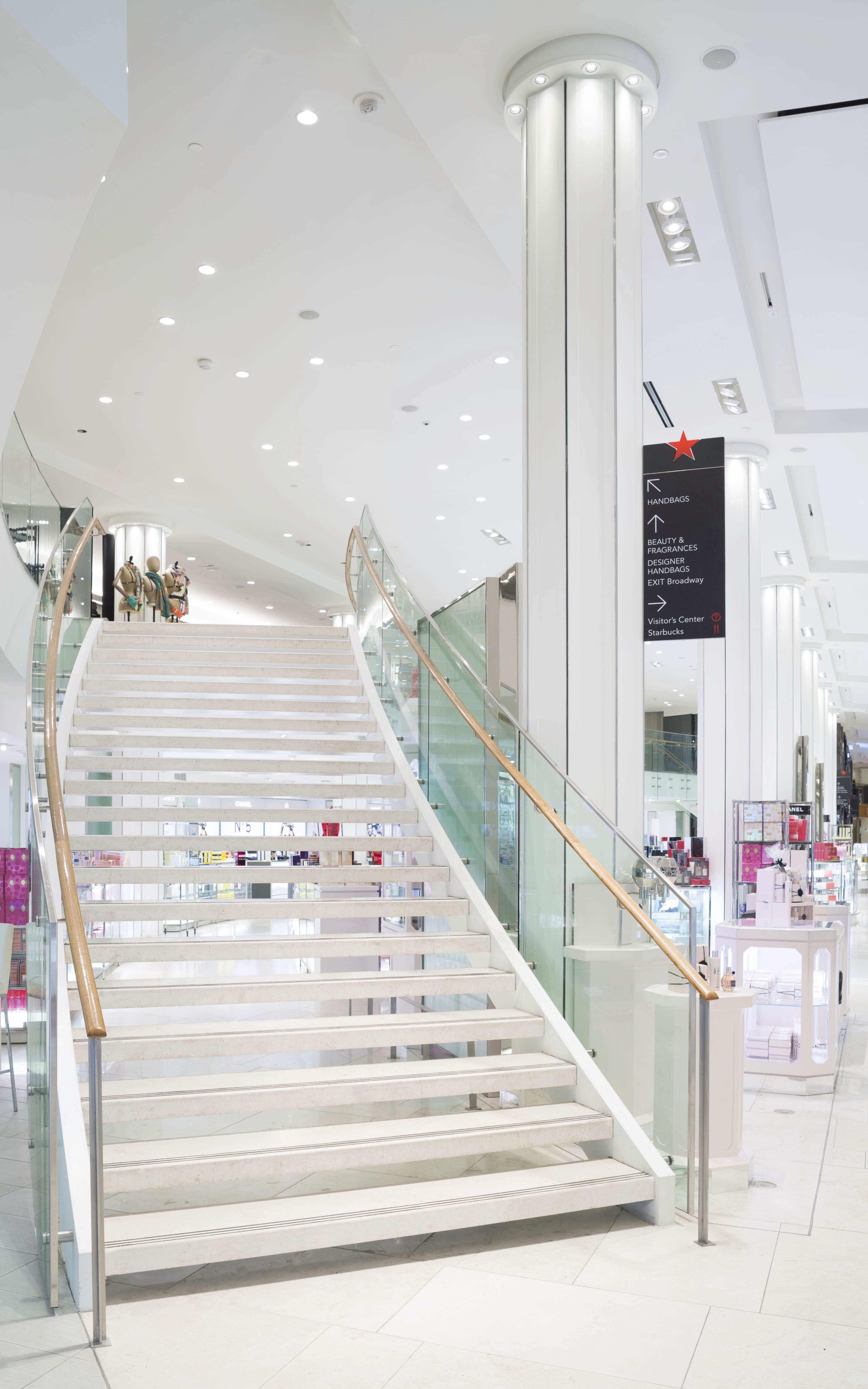 Macy's Herald Square interior directional column-mounted sign with store branding, designed by Two Twelve