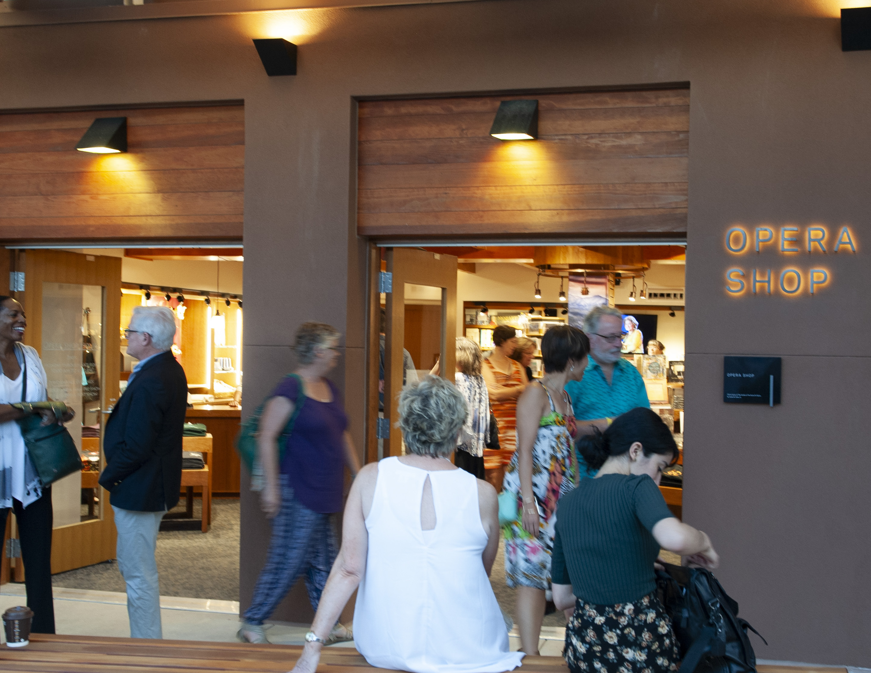 The Santa Fe Opera opera shop halo illuminated stainless steel signs with ADA room sign, designed by Two Twelve