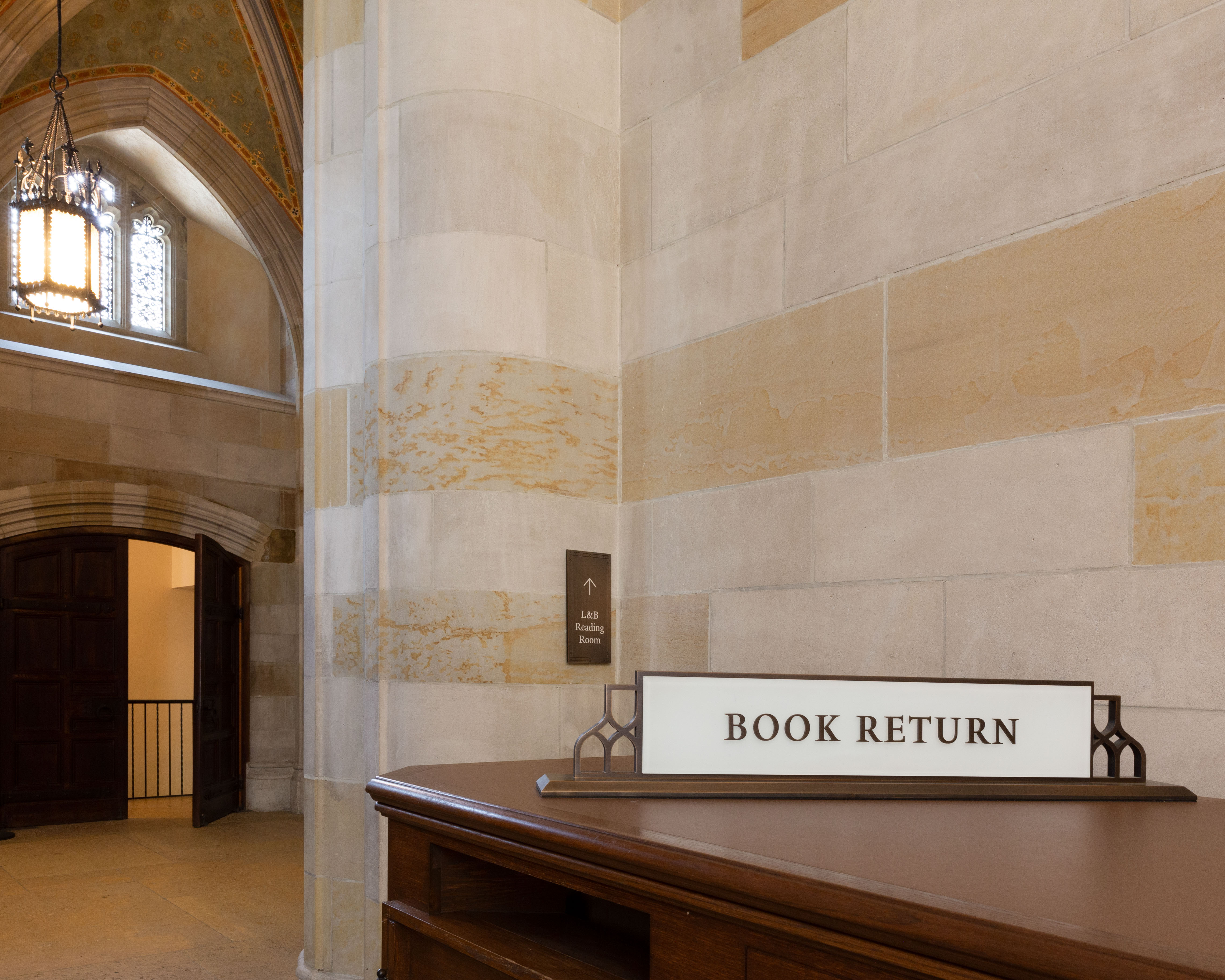 Yale Sterling Memorial Library book return and directional signage mounted to historic wall, designed by Two Twelve