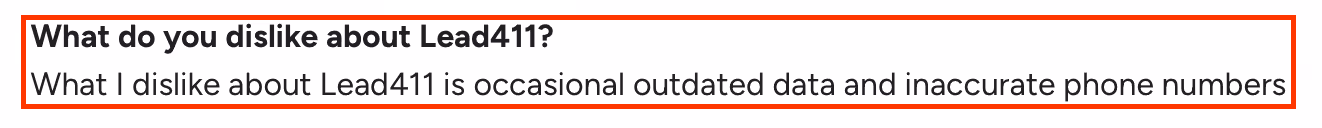 Screenshot of a G2 review where a user mentions their dislike about Lead411, citing occasional outdated data and inaccurate phone numbers.