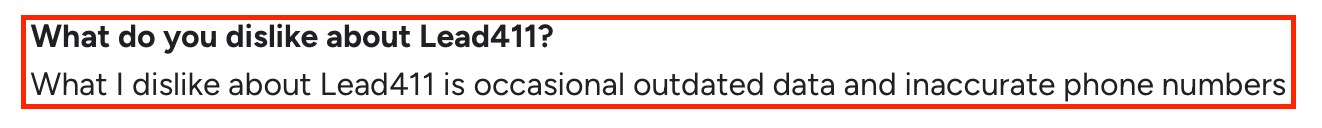 Screenshot of a G2 review where a user mentions their dislike about Lead411, citing occasional outdated data and inaccurate phone numbers.