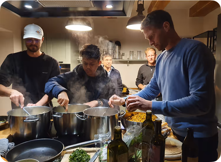 Klim team on summer offsite cooking dinner