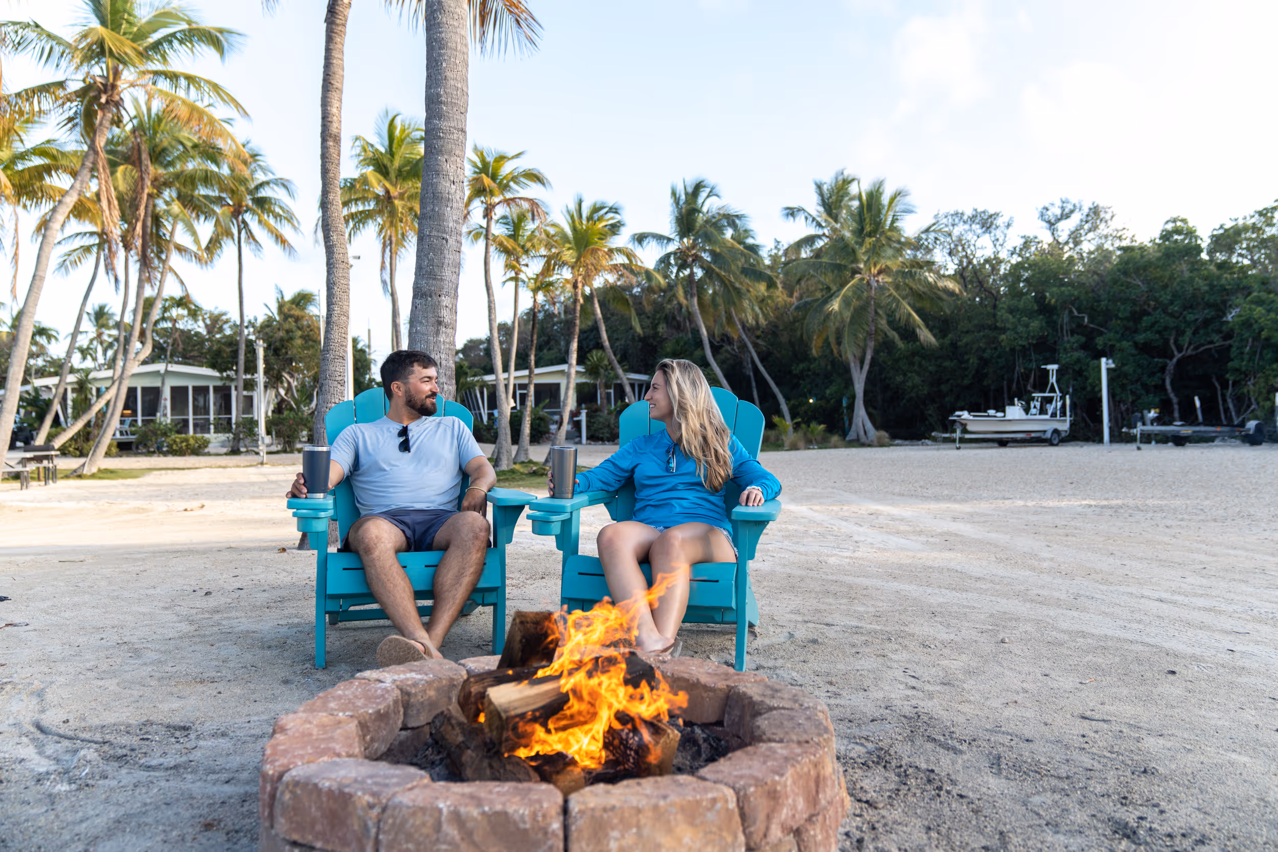 A couple sits around the fire pit on the beach at Kon Tiki Resort in Islamorada.