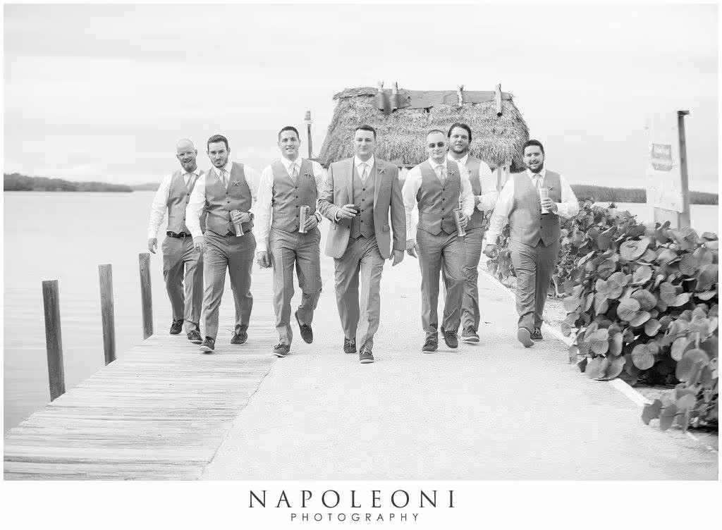 Groom and groomsmen walking down the Kon Tiki Resort dock.
