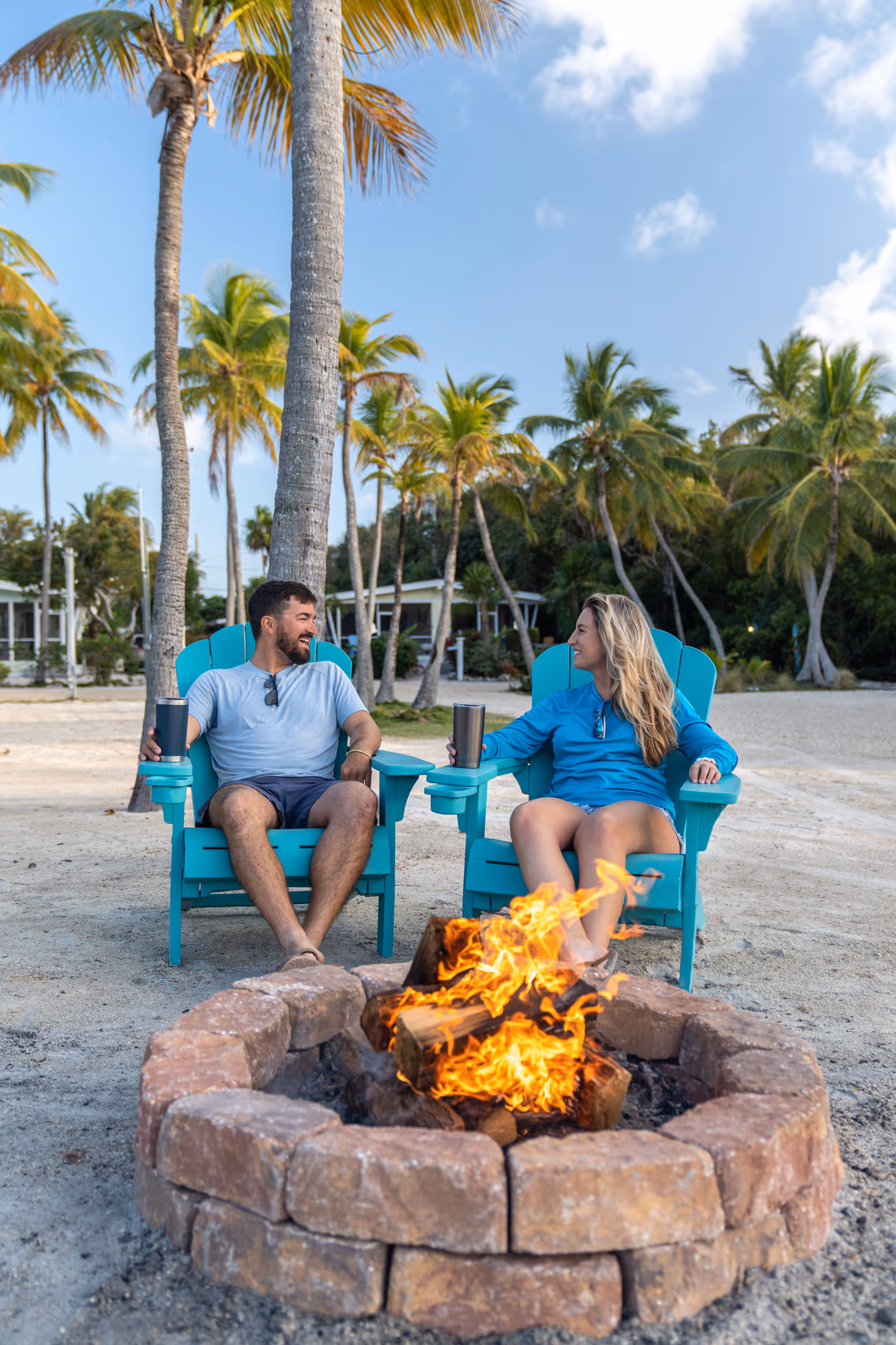 A couple sits around the fire pit on the beach at Kon Tiki Resort in Islamorada.