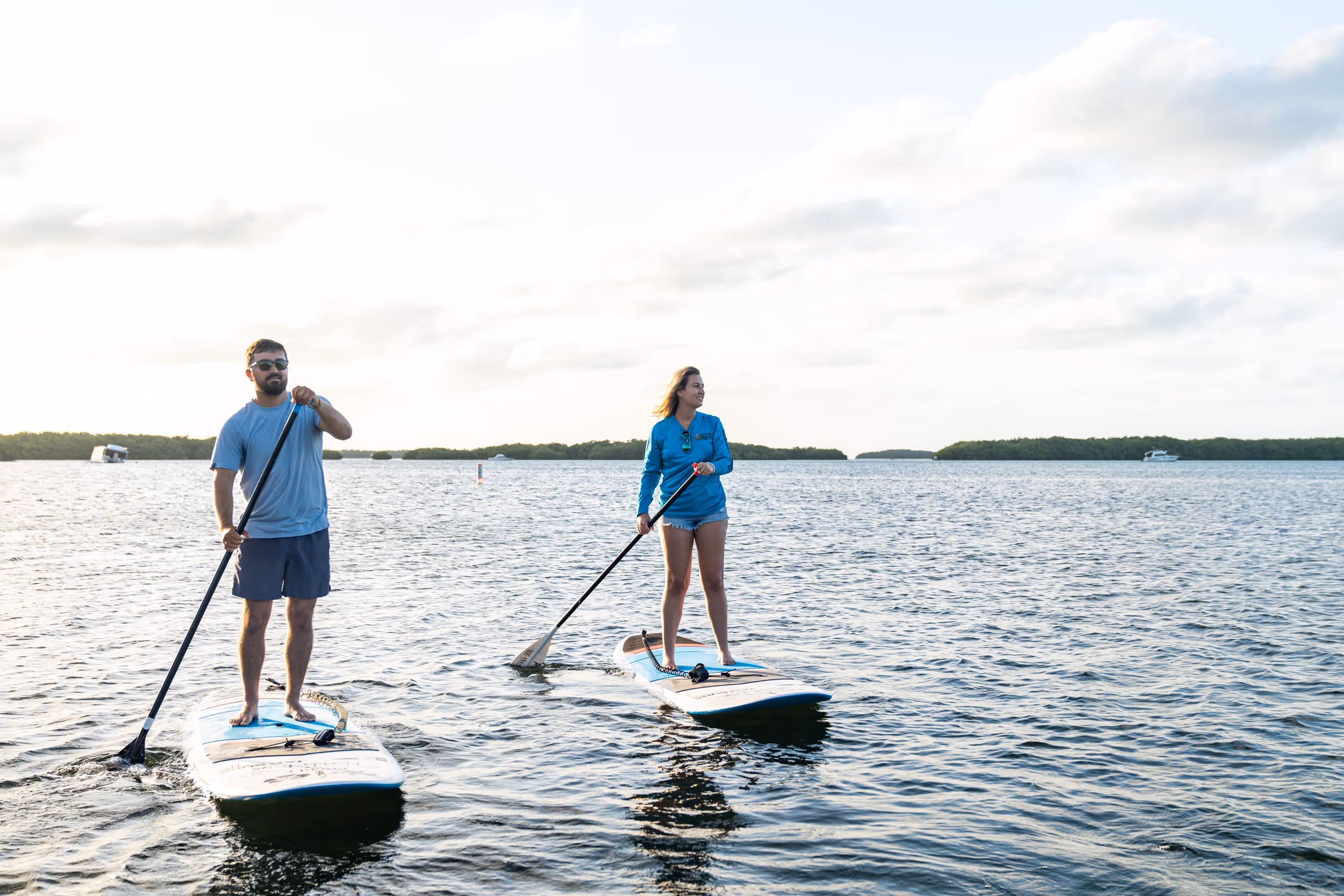 Two Kon Tiki guests paddleboard in the Florida Bay