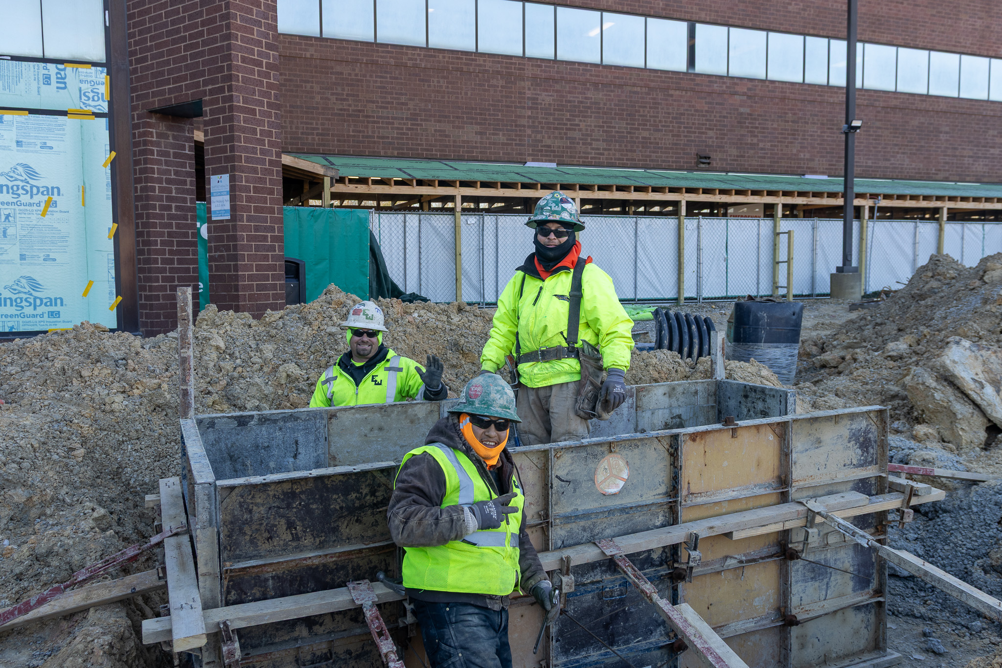 two construction workers on a contracting job in kentucky shake hands
