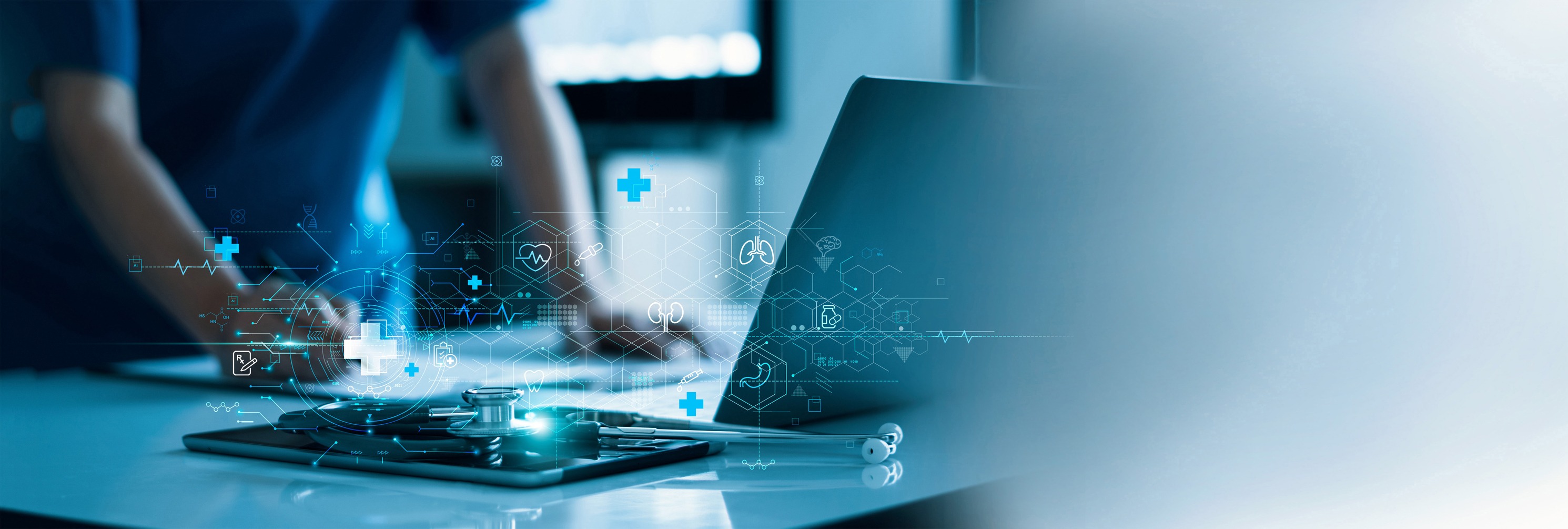 Healthcare professional using a laptop with a stethoscope on a tablet nearby, overlaid with glowing blue medical and technology icons representing digital health.