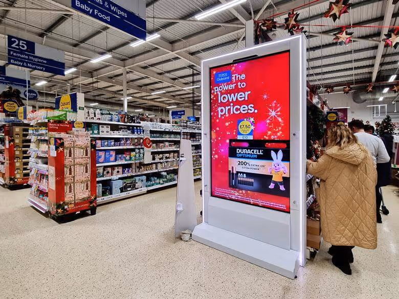 Virtual display ad screen at Tesco showcasing Duracell batteries at the end of an aisle