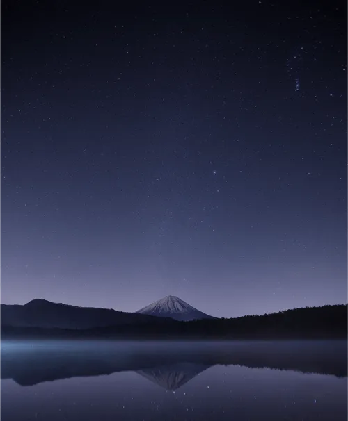 A mountain during the night with sky full of stars