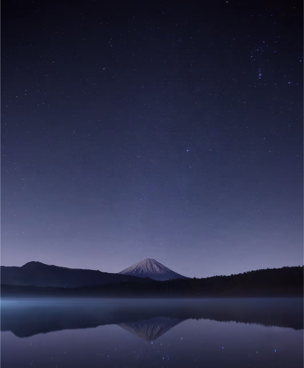A mountain during the night with sky full of stars