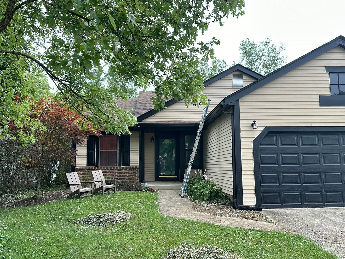 Beige vinyl siding with black trim on the front of a residential home
