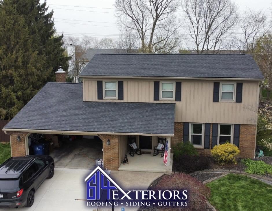Two-story brick and beige siding home with dark gray roof installed by 614 Exteriors