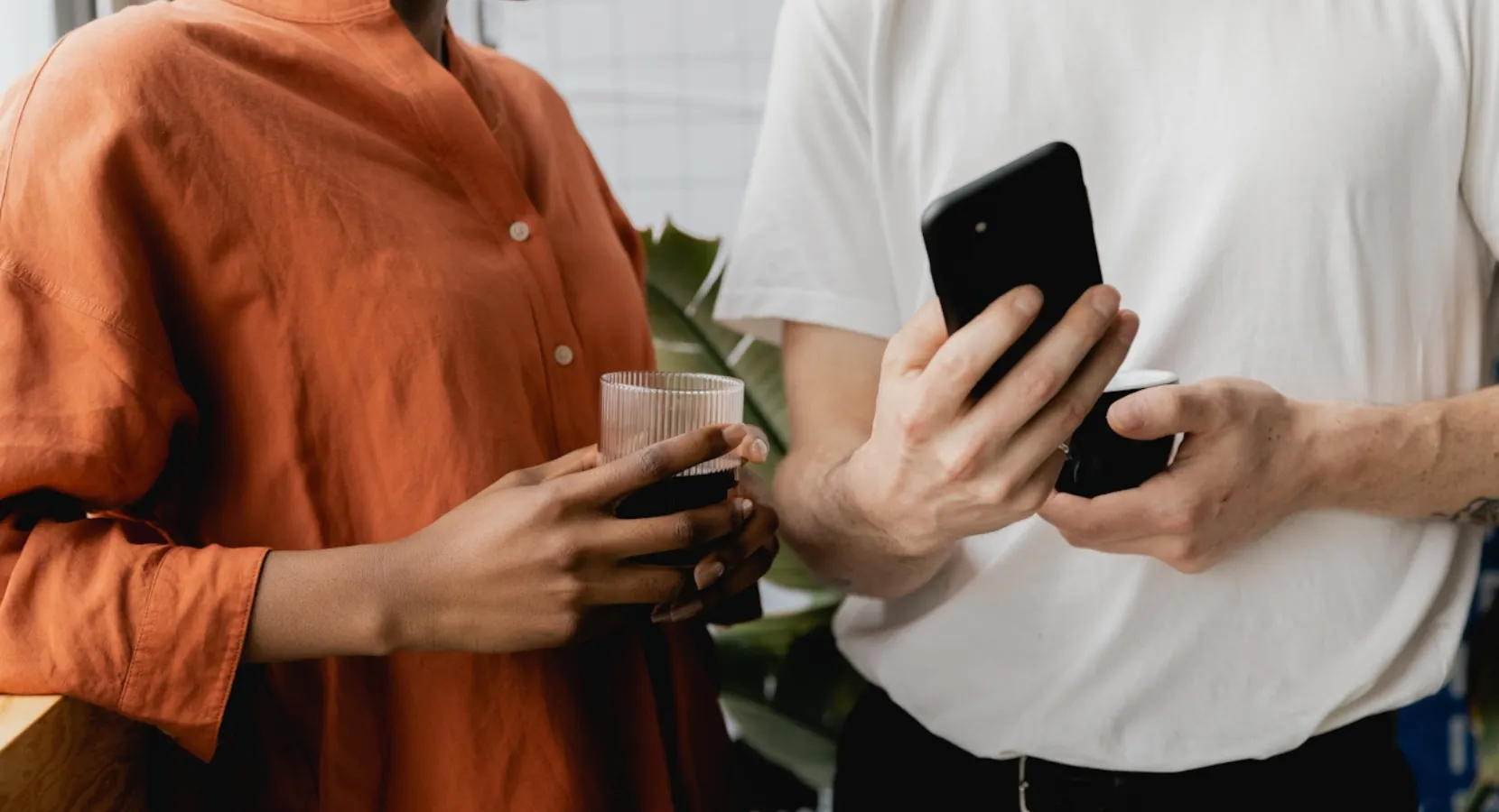 Man showing a woman something on his phone