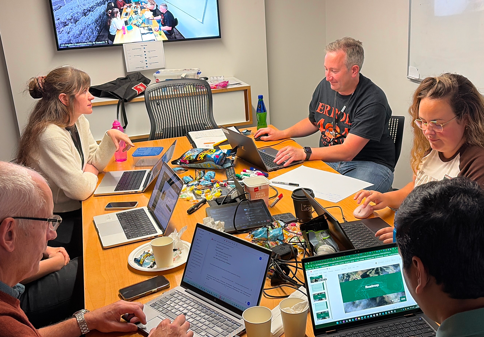 Group of people working on computers at a table