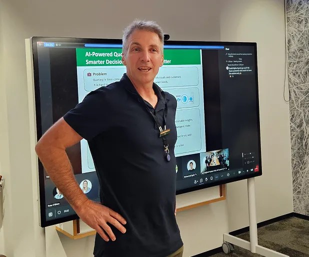 Man standing in front of a TV screen