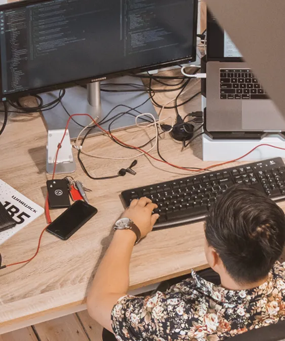 Looking down on a person at their computer desk