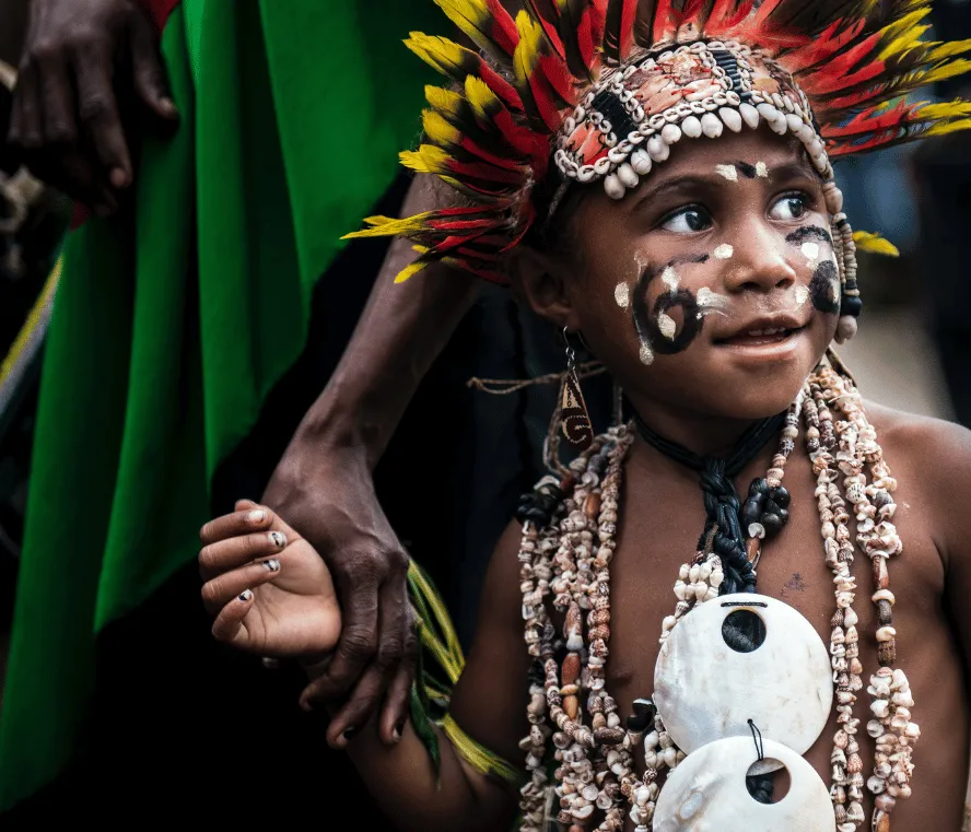 Indigenous child in traditional costume. Photo by Muhammad Nasir on Unsplash