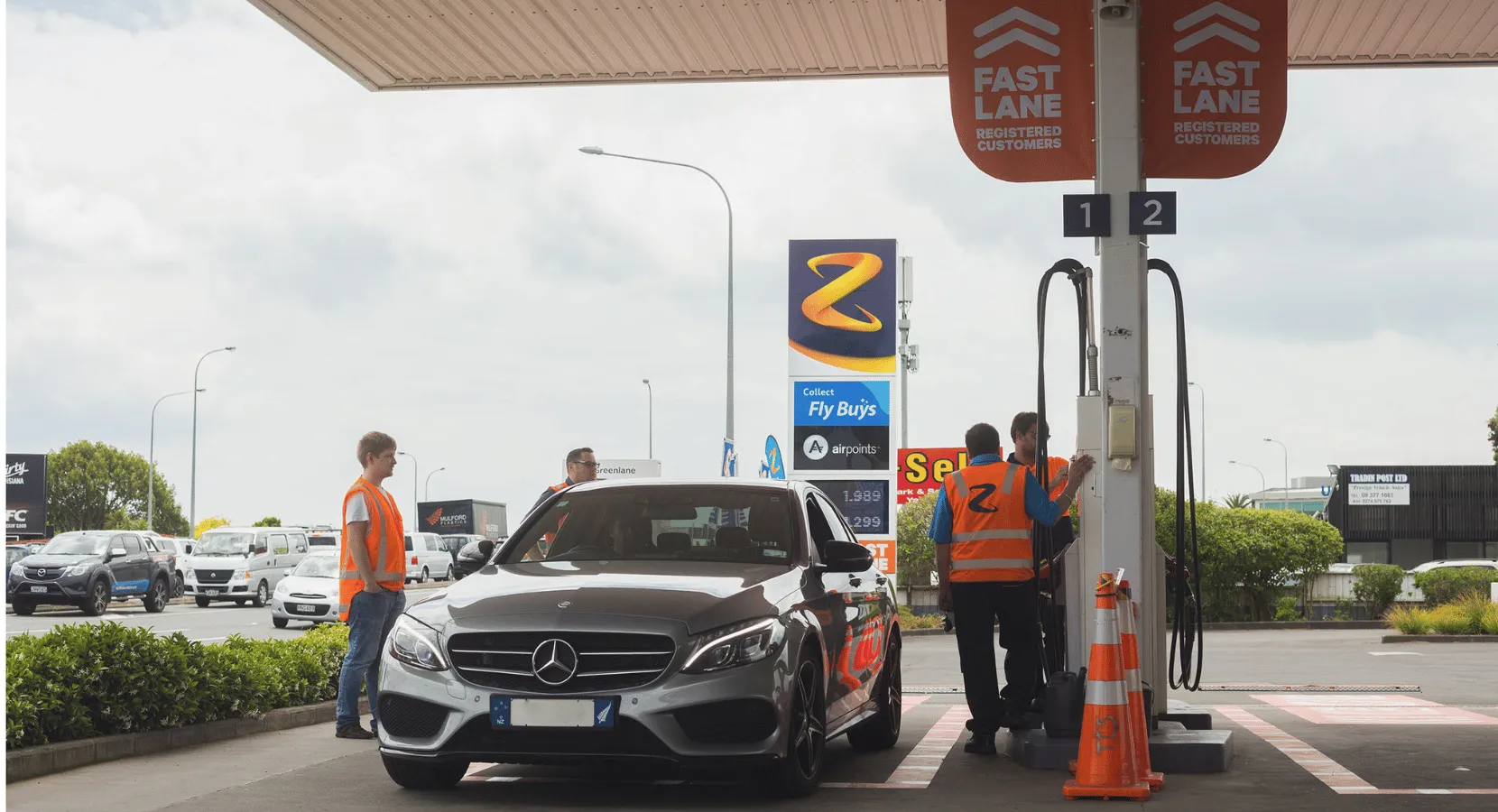 Two cars parked at a Z petrol pump