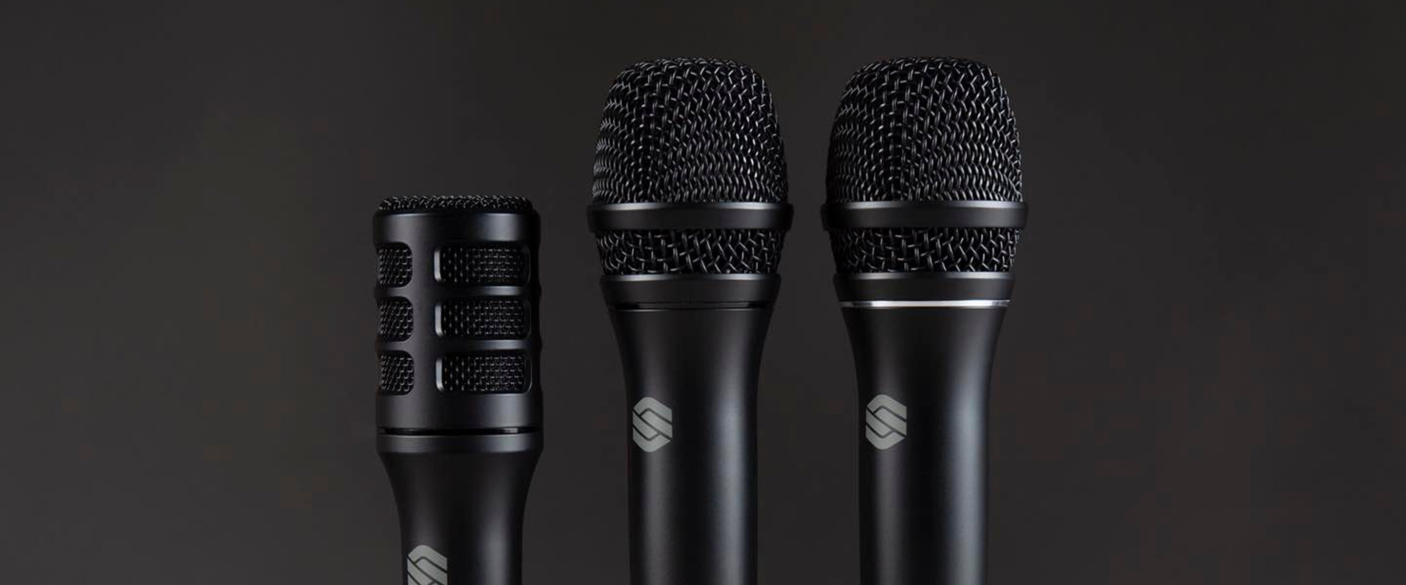 Three black Sterling microphones from the Performance Microphone range shown upright