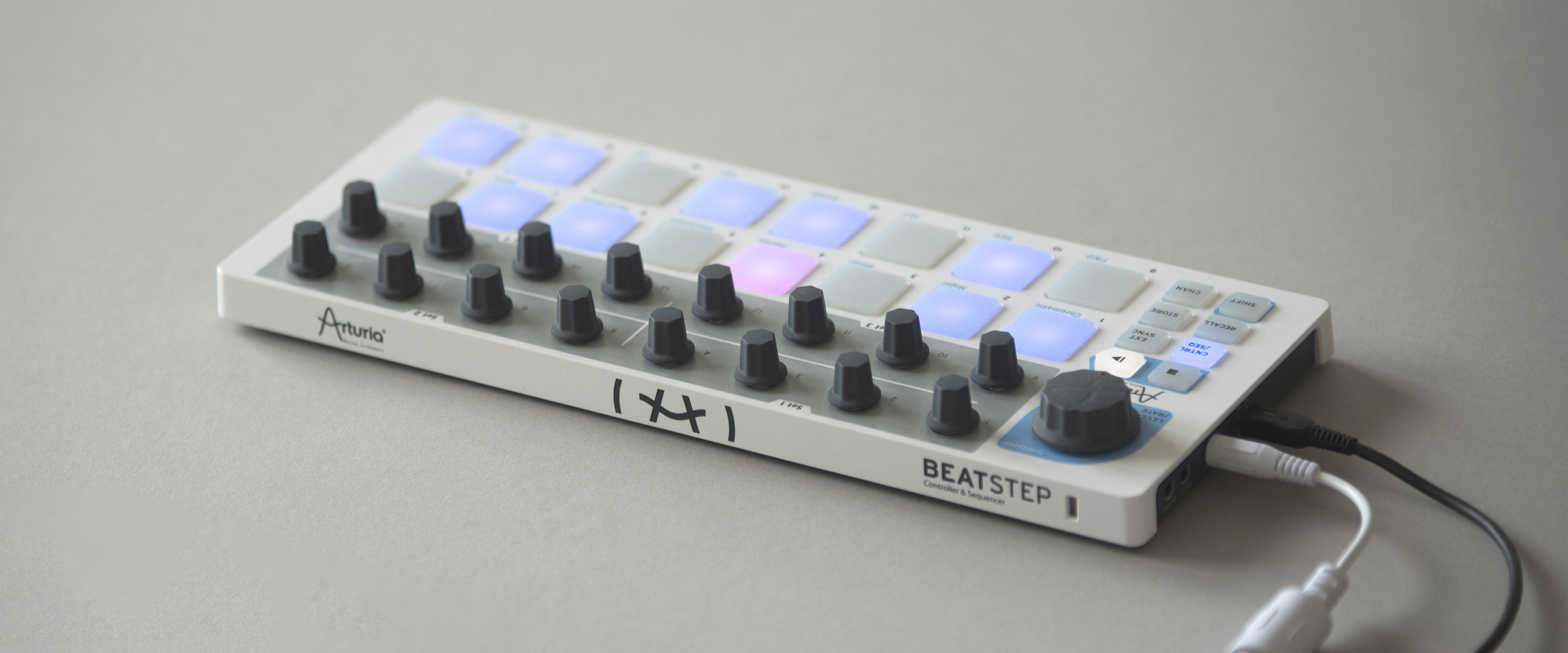 The Arturia BeatStep Pro on a reflective gray surface