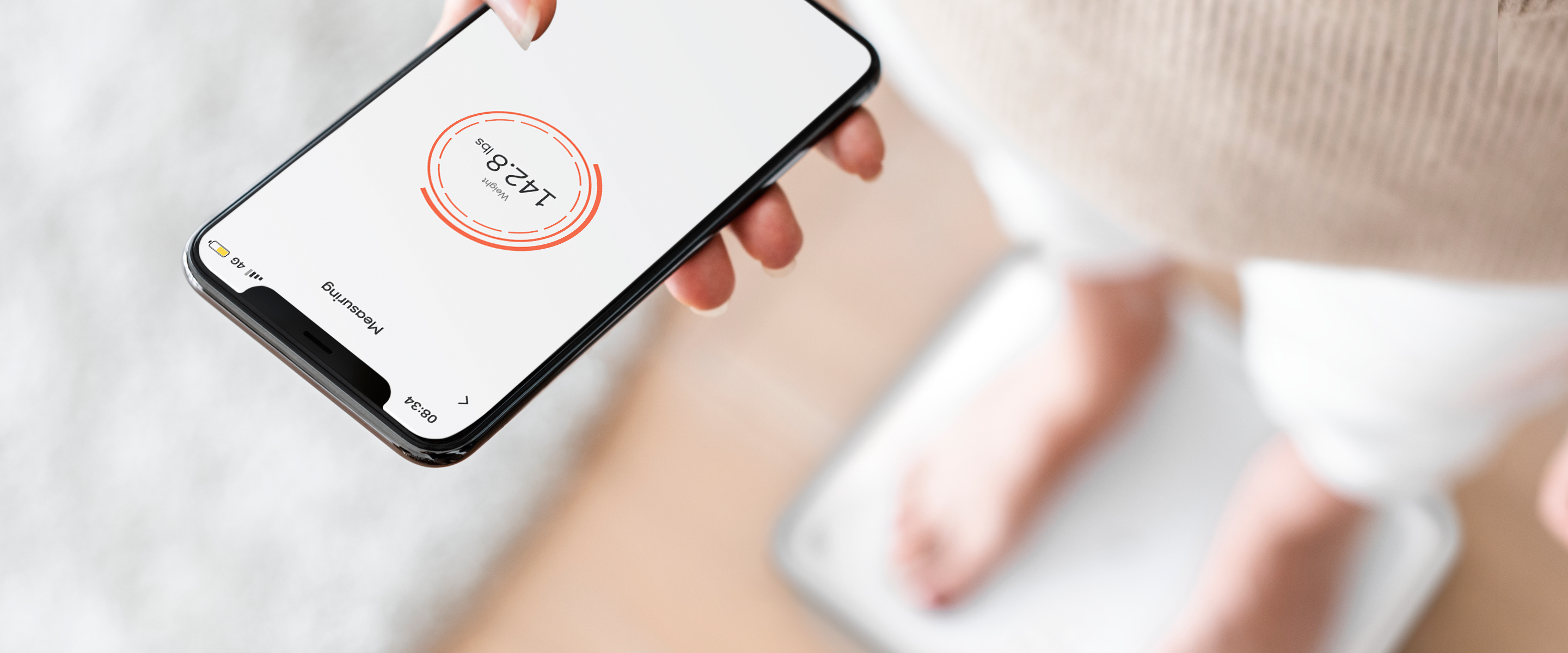 The Sharper Image SpaStudio Digital Scale sits on a wooden floor