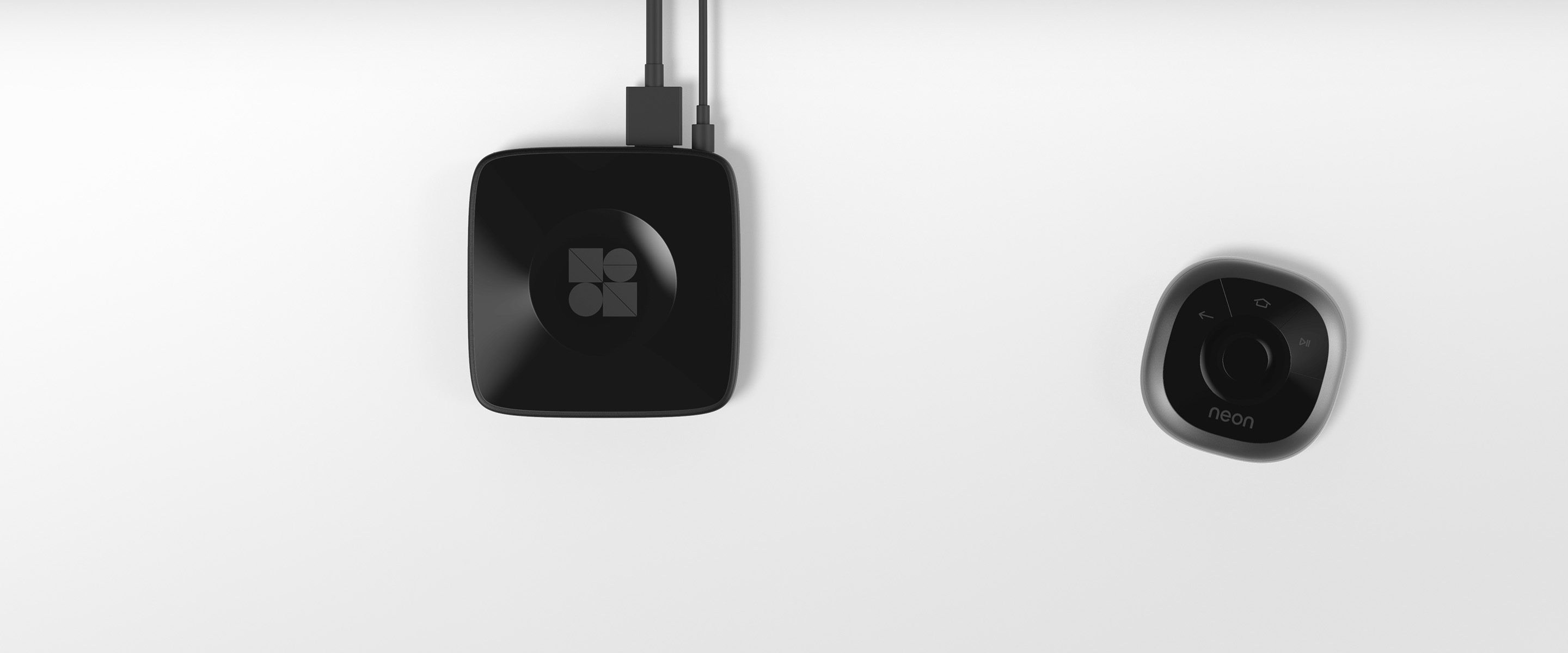 A close up shot of the Neon streaming remote and dock on a dark background