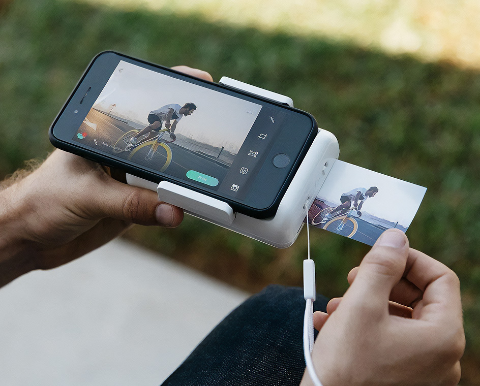 A man prints out a photo from the Lifeprint Instant Print Camera for iPhone