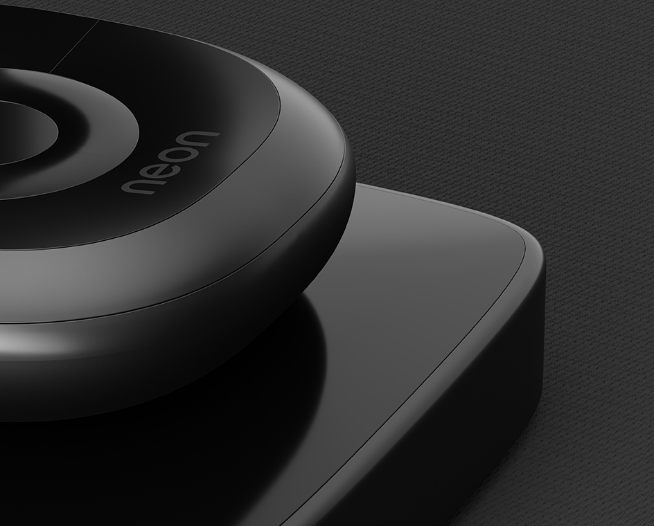 A close up shot of the Neon streaming remote and dock on a dark background