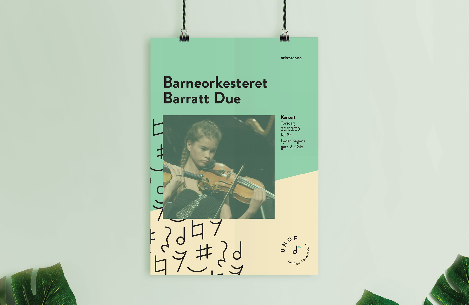 A UNOF poster hanging on a wall next to a plant.