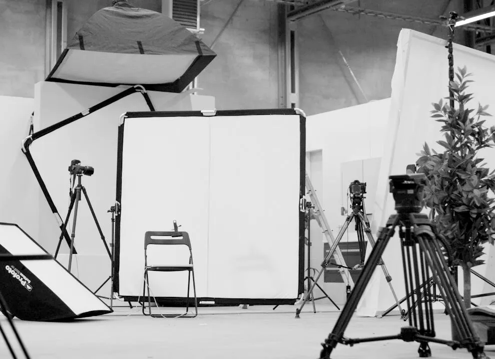 Minimalist bathroom interior with Alterna white wall-mounted vanity unit, rectangular illuminated mirror, light wood floating shelf, white subway tiles, and polished concrete floor.