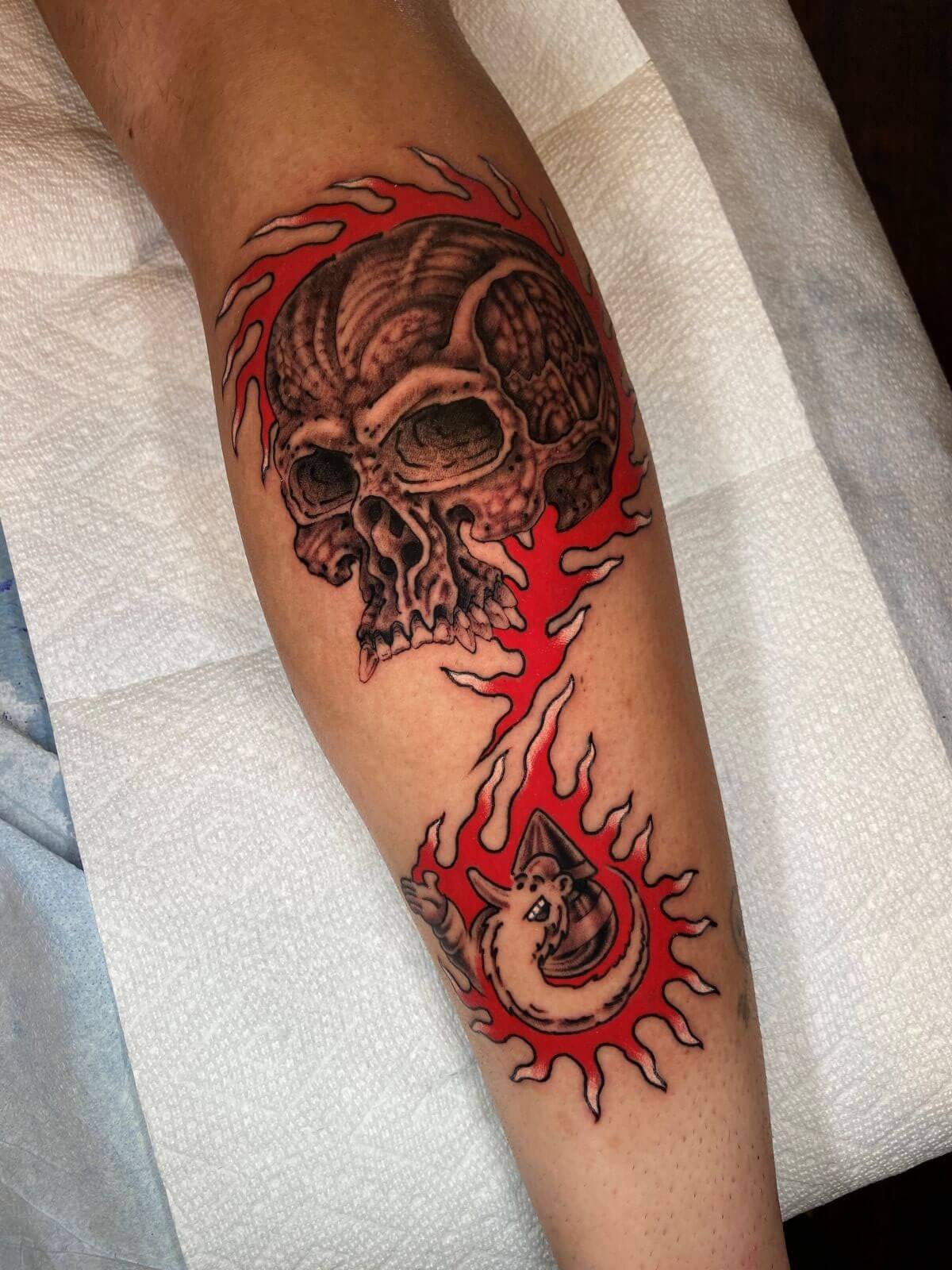 Flaming bio-mech skull with small, bearded man