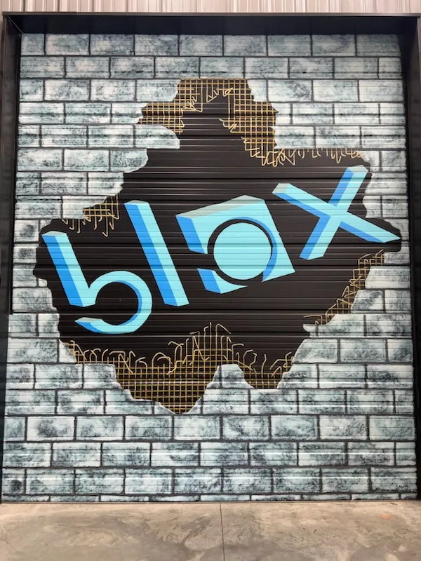 Blox logo artwork on garage door painted by Blow employee