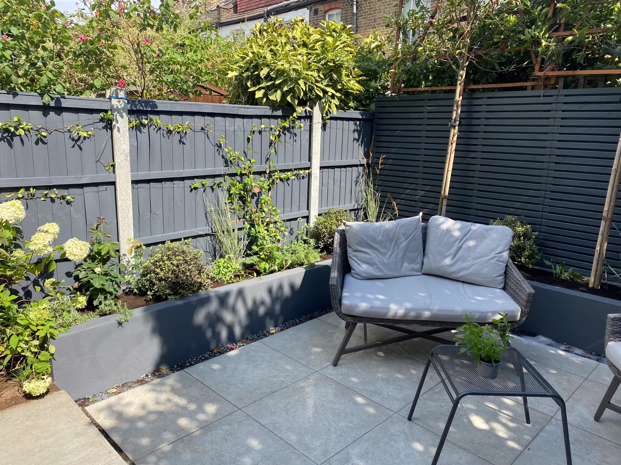 Courtyard garden design in Bow E3 with vertical planting and custom seating