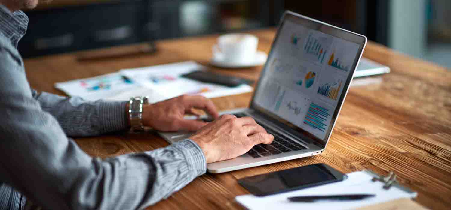 Business owner reviewing marketing web templates on a laptop to build an MSP website