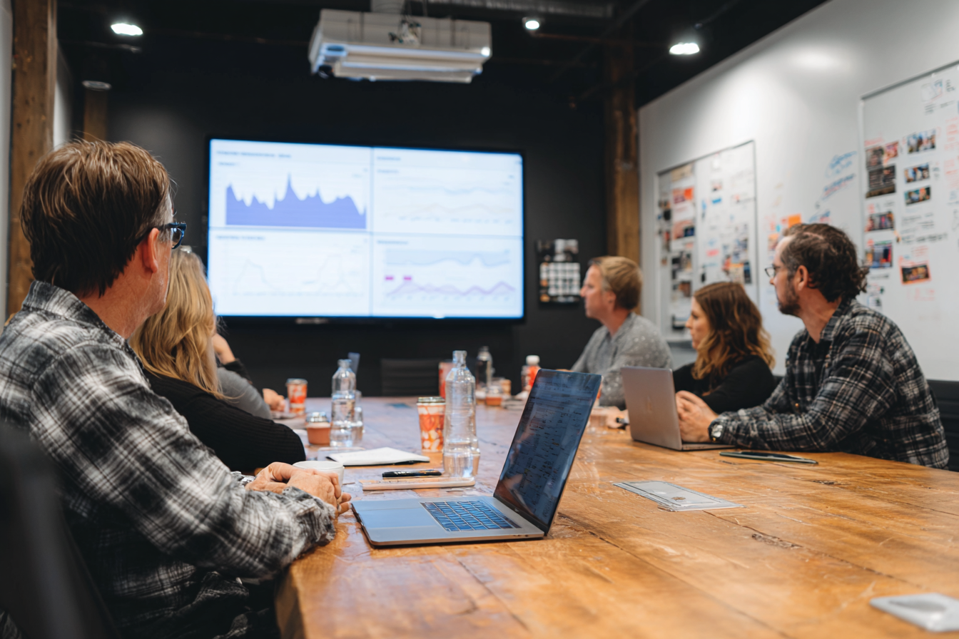 MSP leadership team reviewing campaign performance with their advertising partner in a conference room