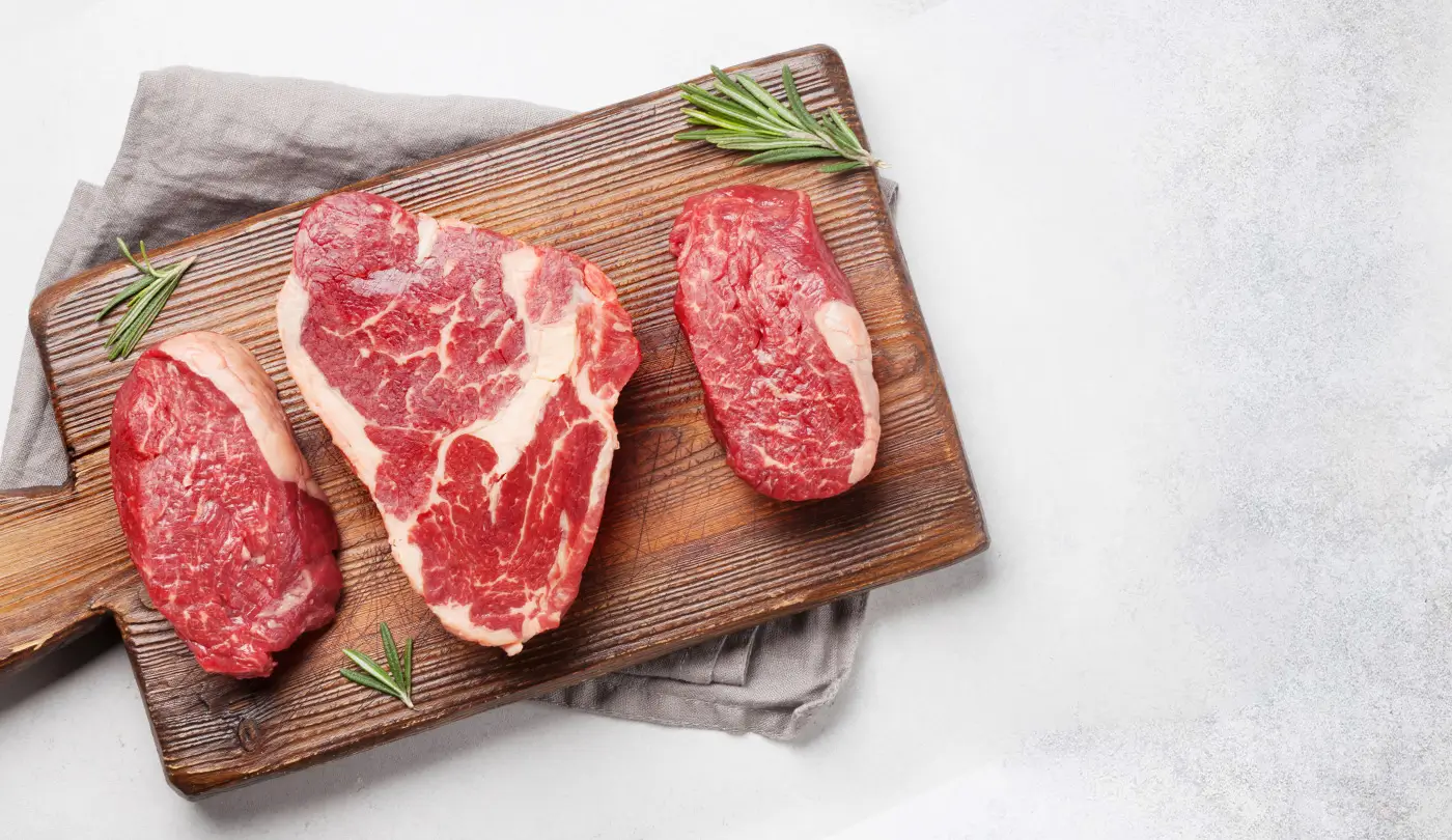 A butcher with steaks on it