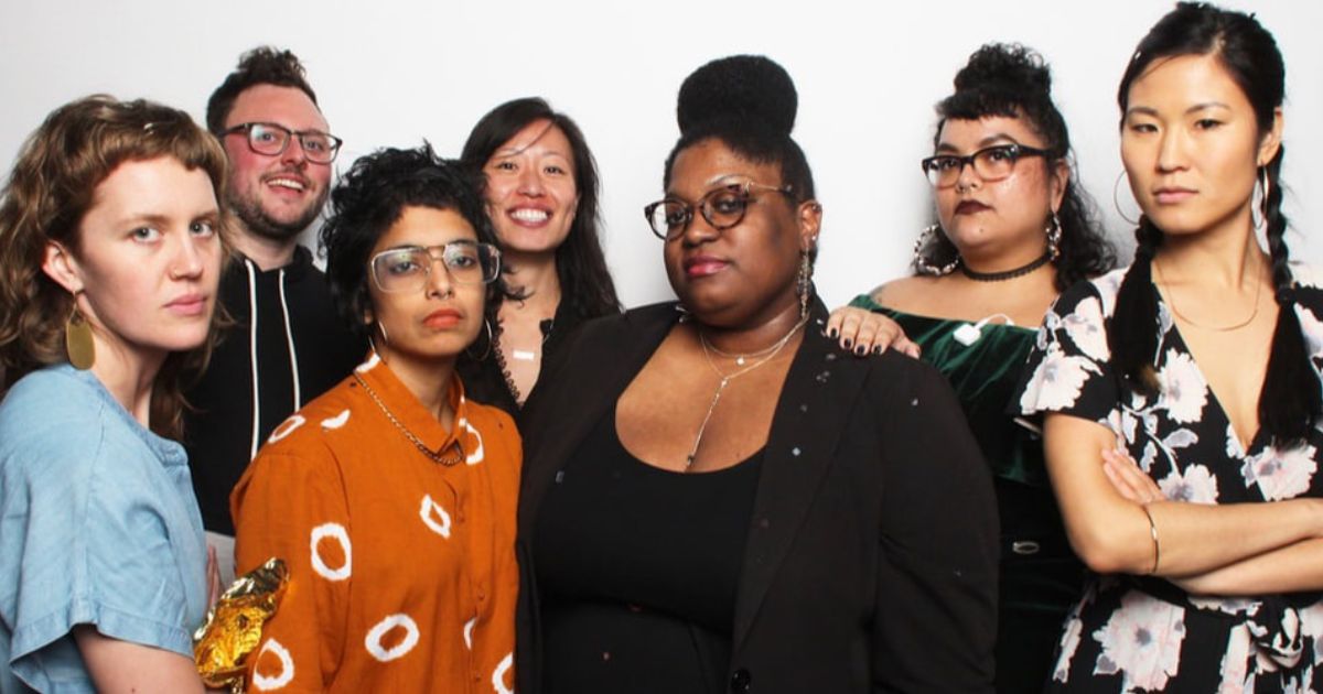 A photo of seven people (Third Wave Fund staff and supporters) grouped in front of a white background and either smiling or looking defiantly at the camera.