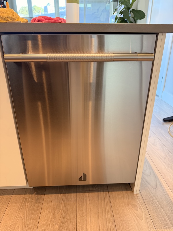 Stainless steel dishwasher cleaned during a kitchen maintenance routine