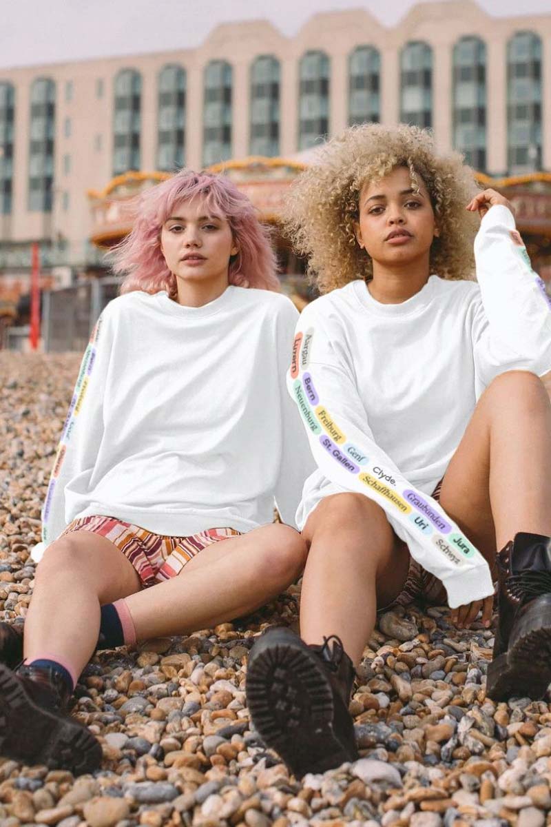 Two Girls sitting with Clyde Tshirts, part of the branding