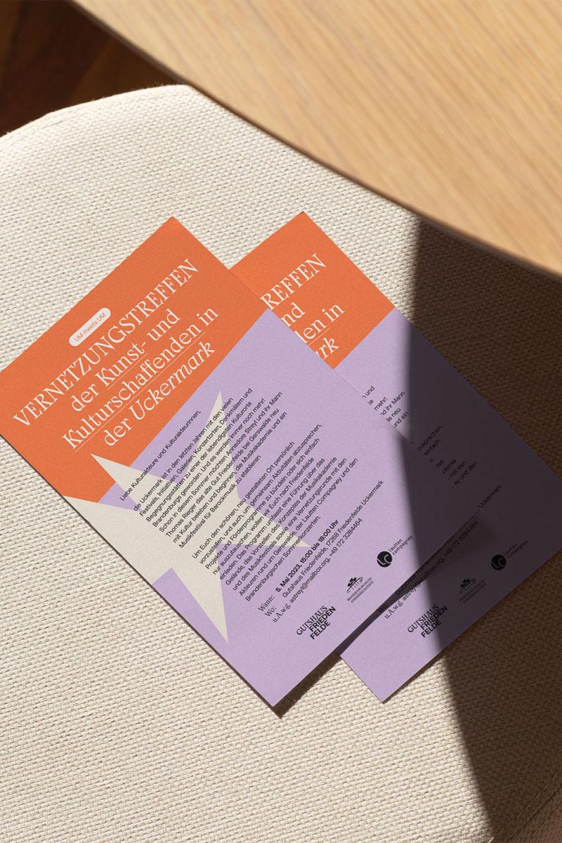 Two flyers spread out on a chair with the table casting a shadow over it.