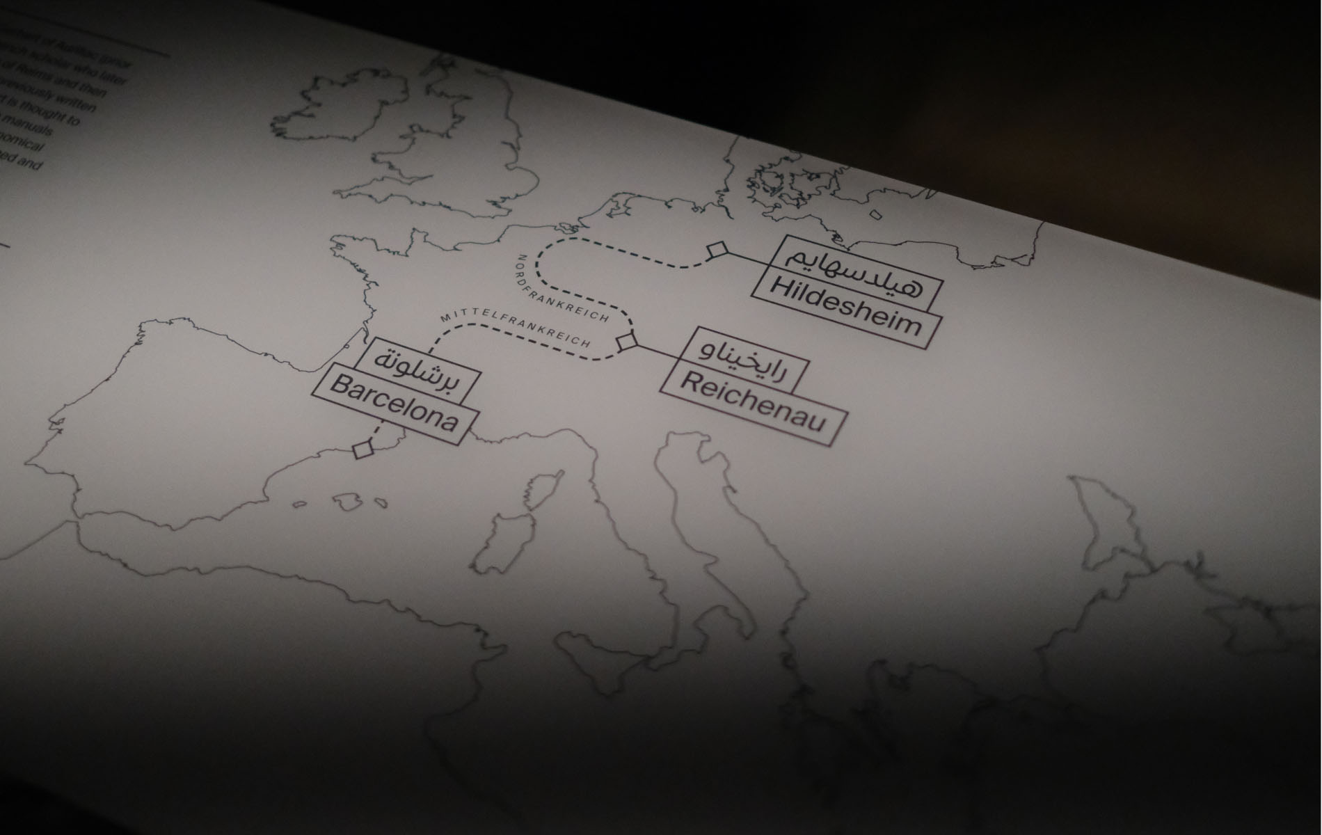 Photo of a european museum map with the cities Barcelona, Reichenau and Hildesheim connected with a dotted line.