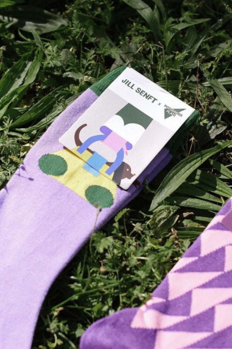 Closeup mage with Purple Socks in Jill Sentf and Potsdamer Platz collaboration on a lawn background, as part of the brand identity design