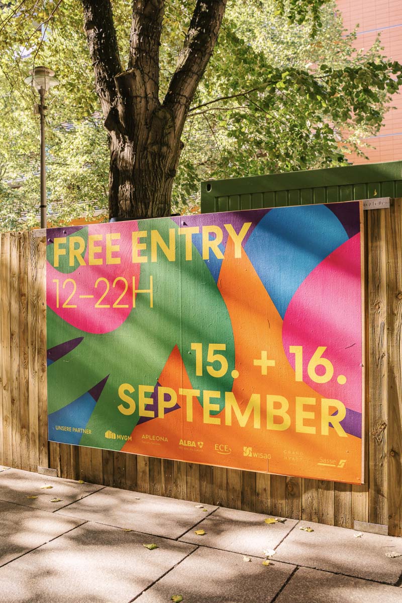 Colorful advertisement Branding of Potsdamer Platz with yellow text reading "Free Entry 12-22H - 15. + 16 September.