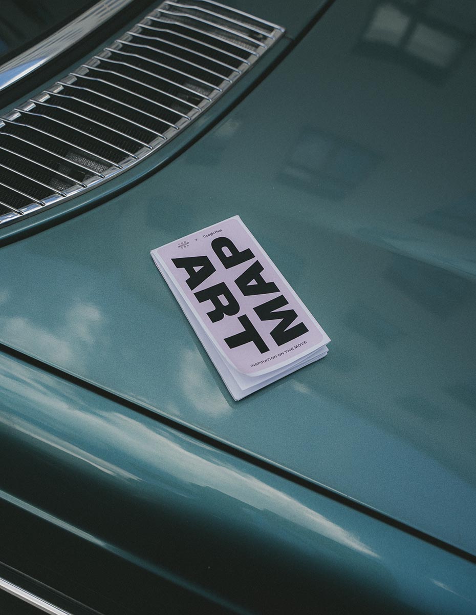An art map placed on the hood of a car, photographed by a Creative Agency focused on Content Creation, Photography for Brands, and Visual Storytelling.
